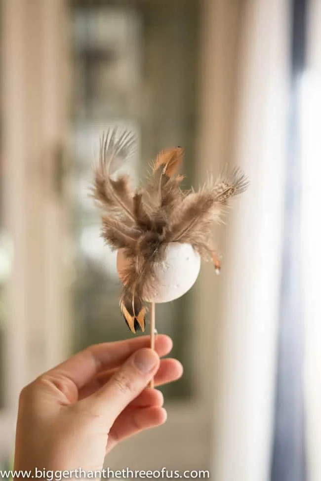 22 Fantastic Feather Crafts 7 6. Feather Ball Ornament